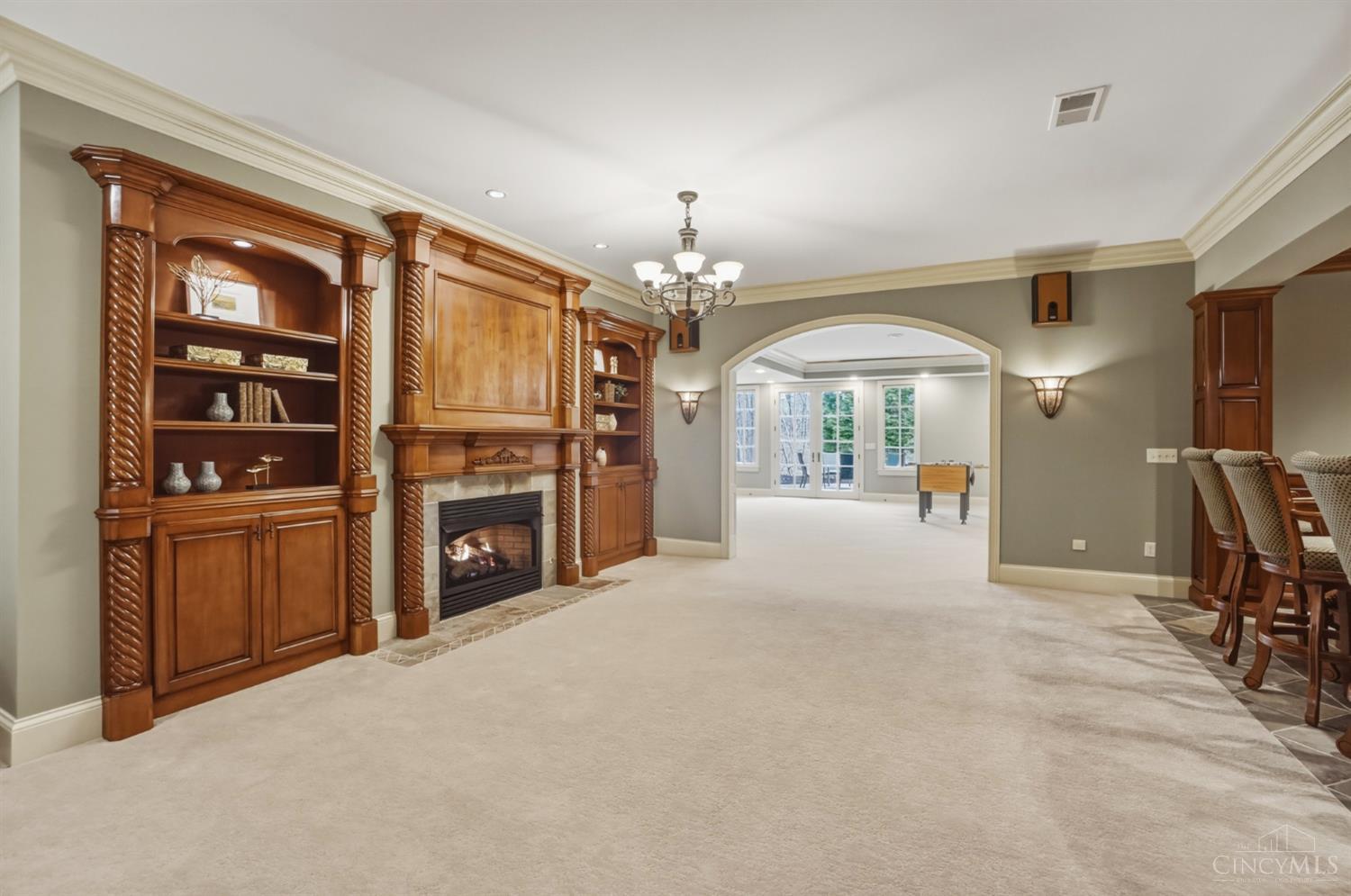 1054 Observatory Point Maineville, OH 45039 - Photo 53 of 82 Built in bookshelves and another gas fireplace in the lower level. Bar is to the right.