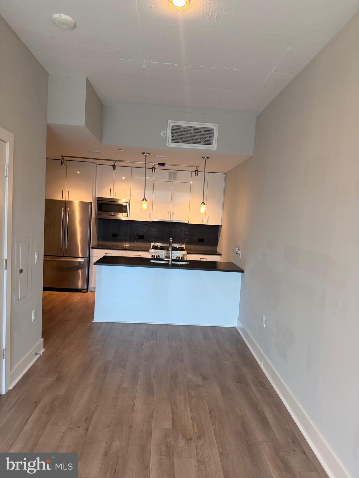 88 V Street Southwest, Unit 810 Washington, DC 20024 - Photo 10 of 14 a kitchen with wooden floors and appliances