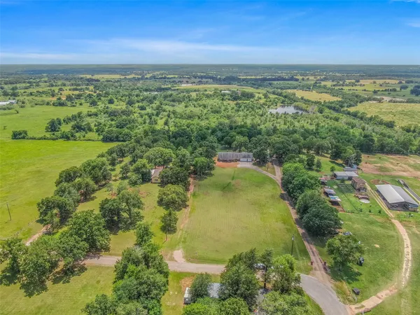 an aerial view of residential houses with outdoor space and swimming pool