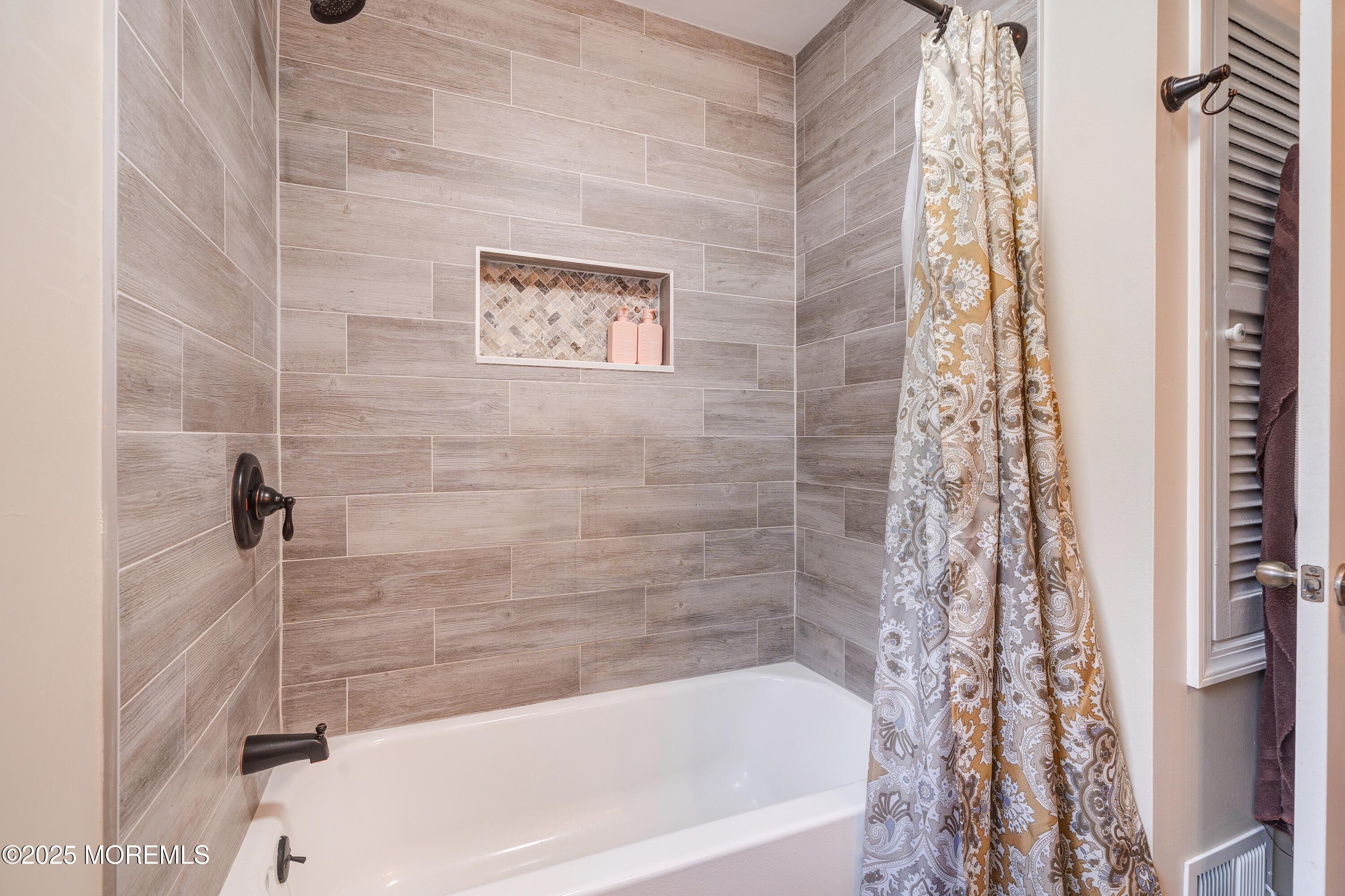 7 Carriage Road Hazlet, NJ 07730 - Photo 17 of 33 a bathroom with a bathtub and shower