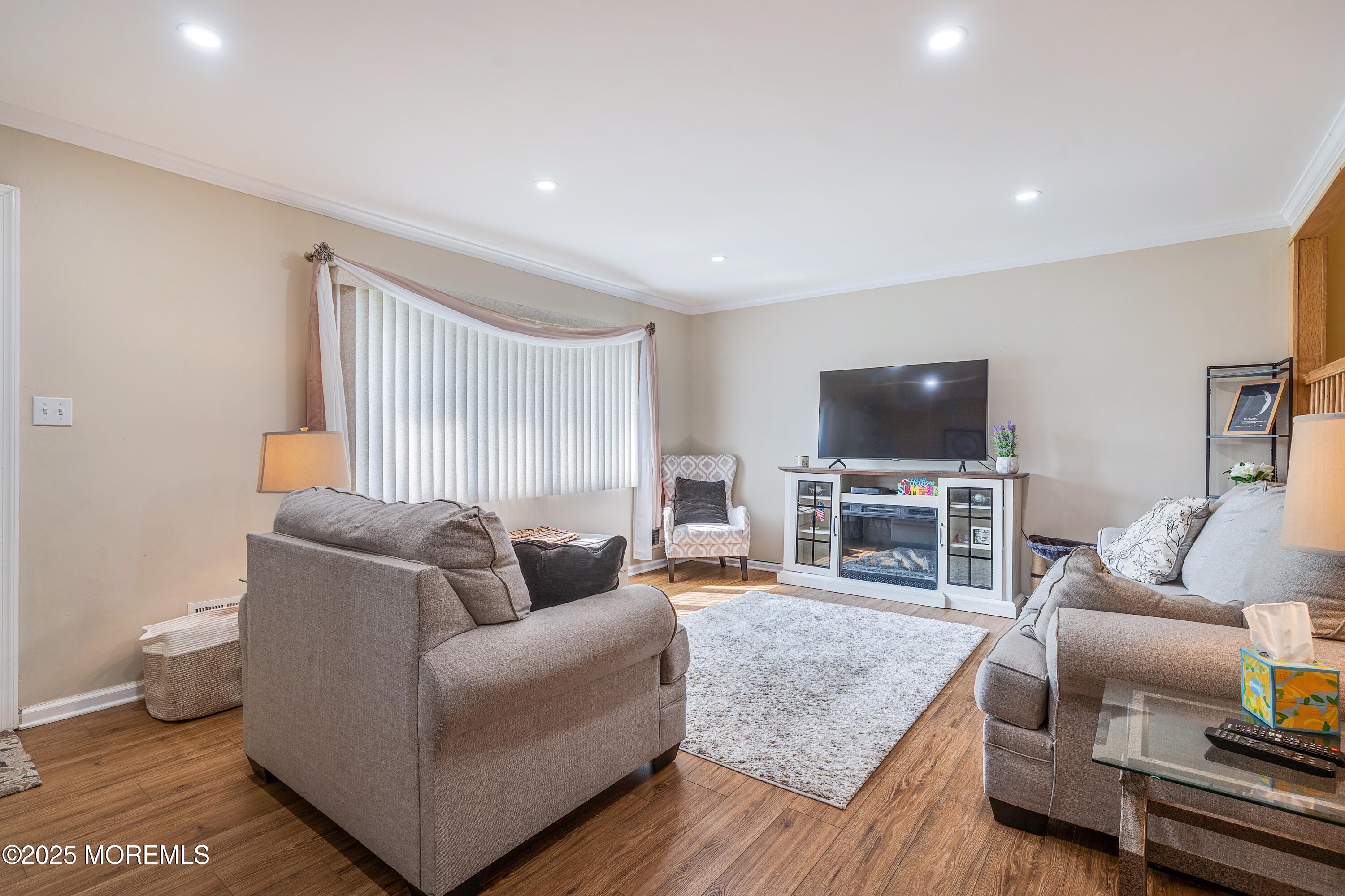 7 Carriage Road Hazlet, NJ 07730 - Photo 5 of 33 a living room with furniture and a flat screen tv