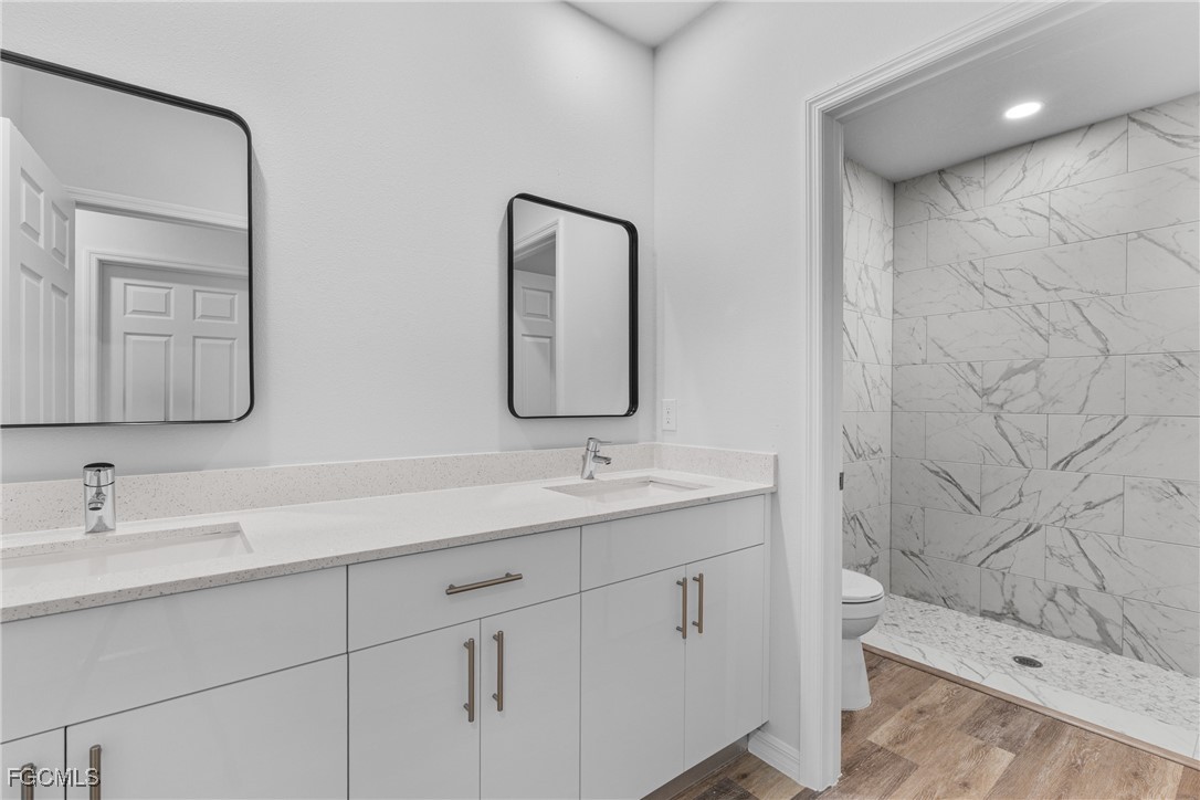 945 Butler Street East Lehigh Acres, FL 33974 - Photo 18 of 34 a bathroom with a sink and a mirror