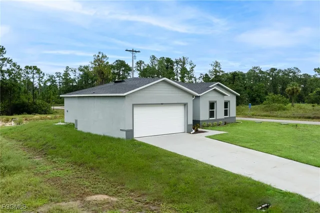 a front view of house with yard and green space