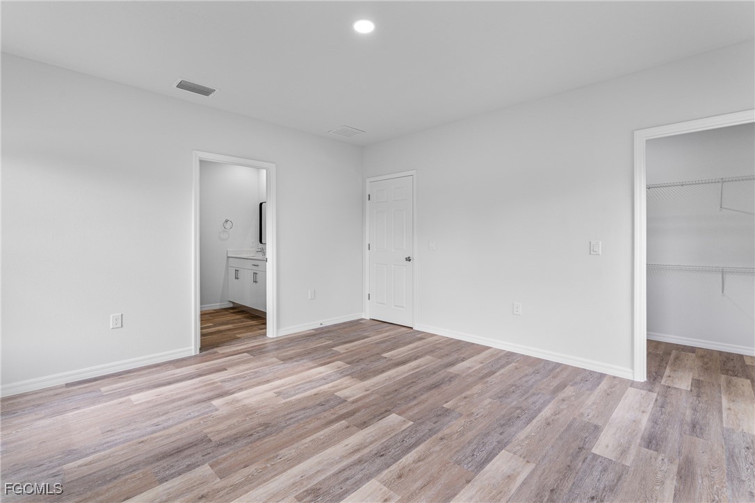 945 Butler Street East Lehigh Acres, FL 33974 - Photo 23 of 34 a view of a room with wooden floor