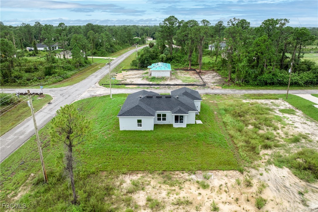 945 Butler Street East Lehigh Acres, FL 33974 - Photo 29 of 34 a view of a house with a yard