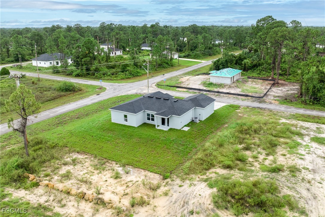 945 Butler Street East Lehigh Acres, FL 33974 - Photo 30 of 34 a view of a house with a yard and lake view