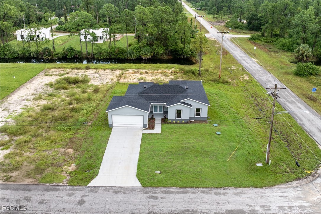 945 Butler Street East Lehigh Acres, FL 33974 - Photo 3 of 34 a view of a house with a yard
