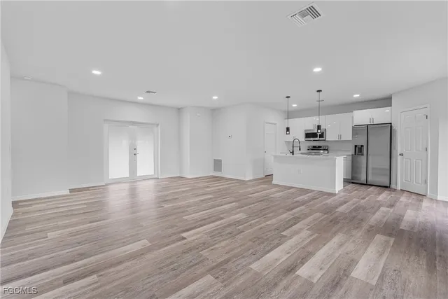 a kitchen with refrigerator cabinets and a sink