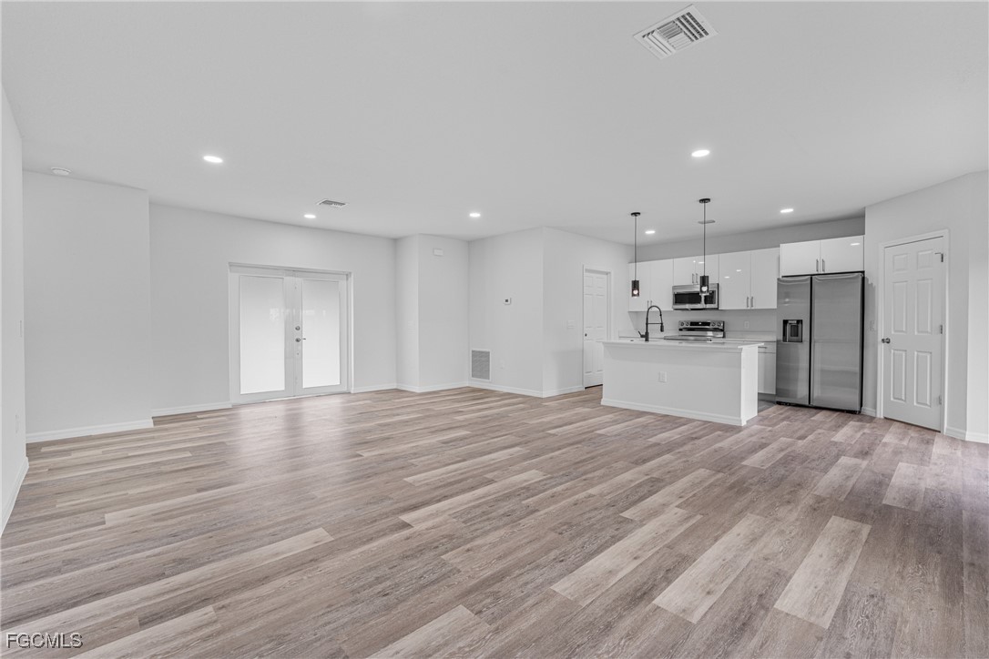 945 Butler Street East Lehigh Acres, FL 33974 - Photo 9 of 34 a view of empty room with wooden floor