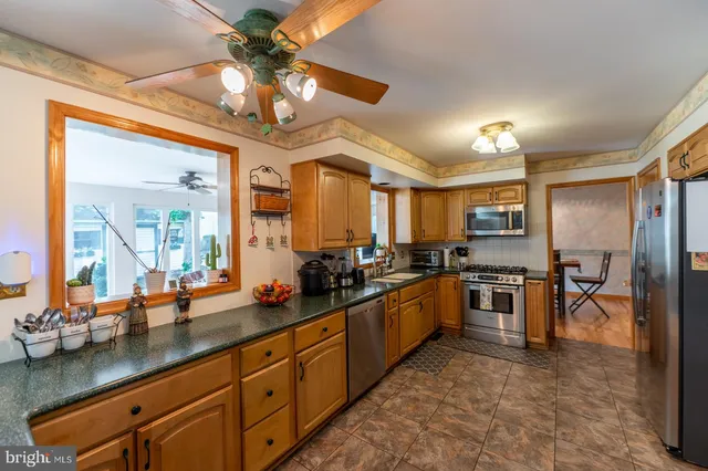 a kitchen with lots of counter top space and stainless steel appliances