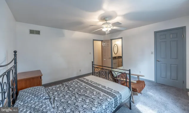 a view of a house with a yard and potted plants