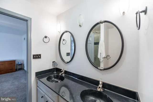 a view of a patio with table and chairs potted plants and a large tree