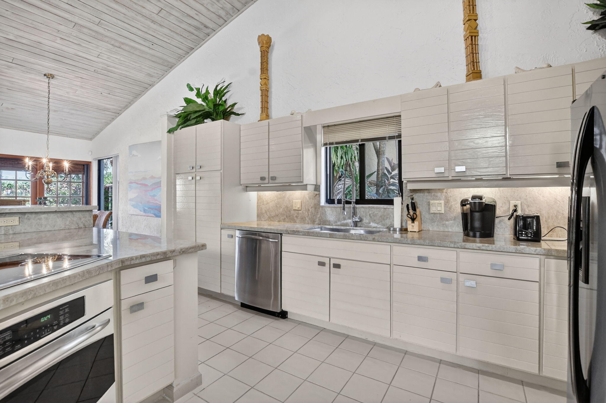 22519 Esplanada Circle, Unit W Boca Raton, FL 33433 - Photo 22 of 57 a kitchen with white cabinets and white appliances