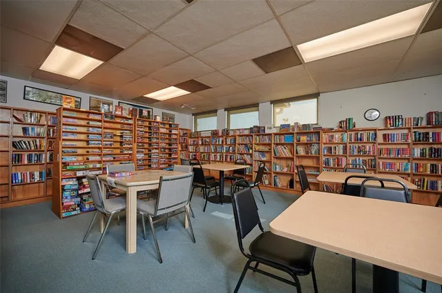 a dining room with a wooden table and chairs
