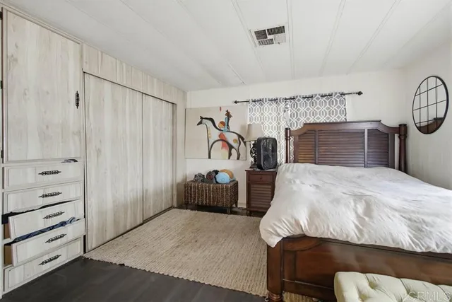 a bedroom with a bed and a television