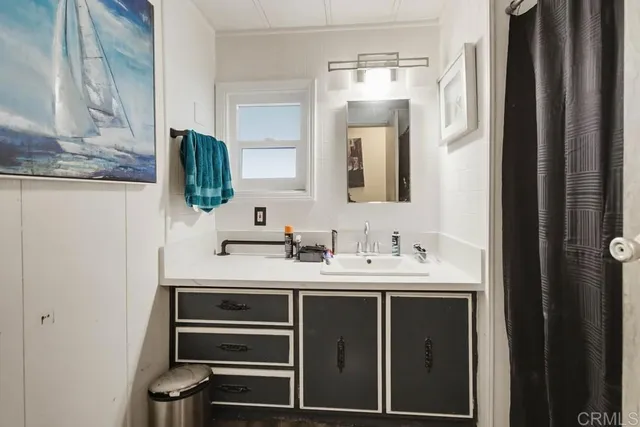 a kitchen with stainless steel appliances granite countertop a refrigerator a stove a dining table and chairs with wooden floor