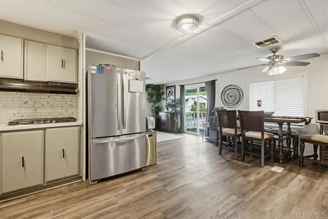 a kitchen with stainless steel appliances a refrigerator and sink