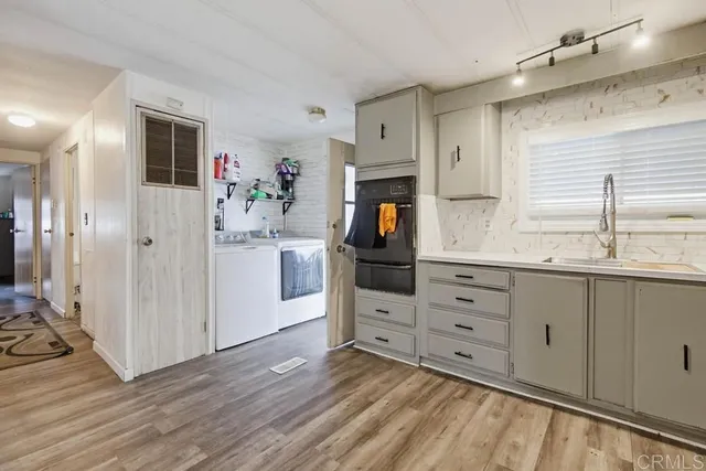 a kitchen with a sink cabinets and appliances