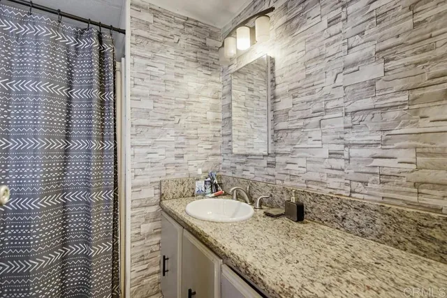 a bathroom with a sink a mirror and a window