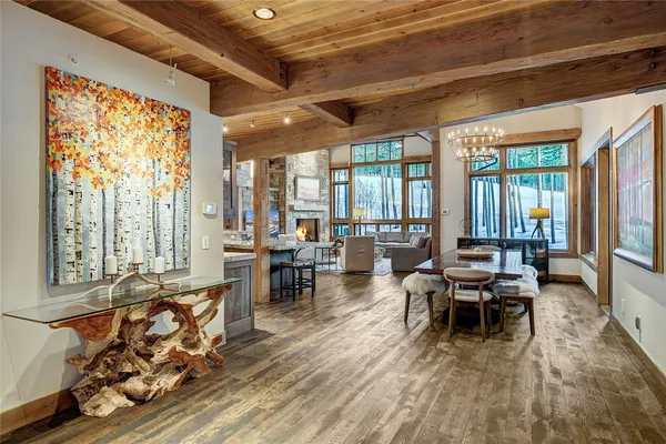 a dining room with furniture a chandelier and wooden floor