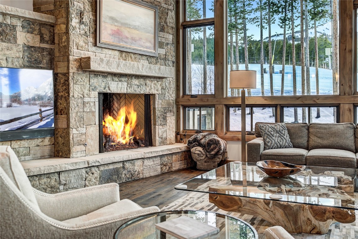 422 Timbertrail Road Breckenridge, CO 80424 - Photo 16 of 50 Living area with a stone fireplace and wood-type flooring