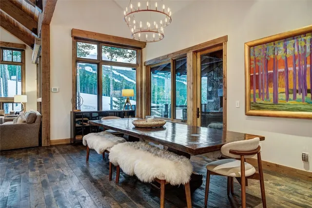 a bedroom with a bed a mirror and a large window