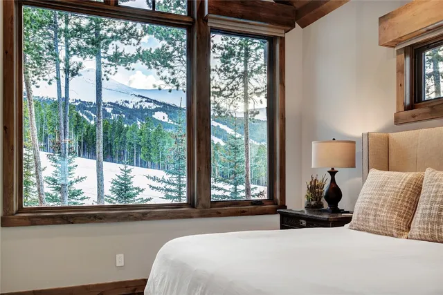 a bedroom with a bed and a large window