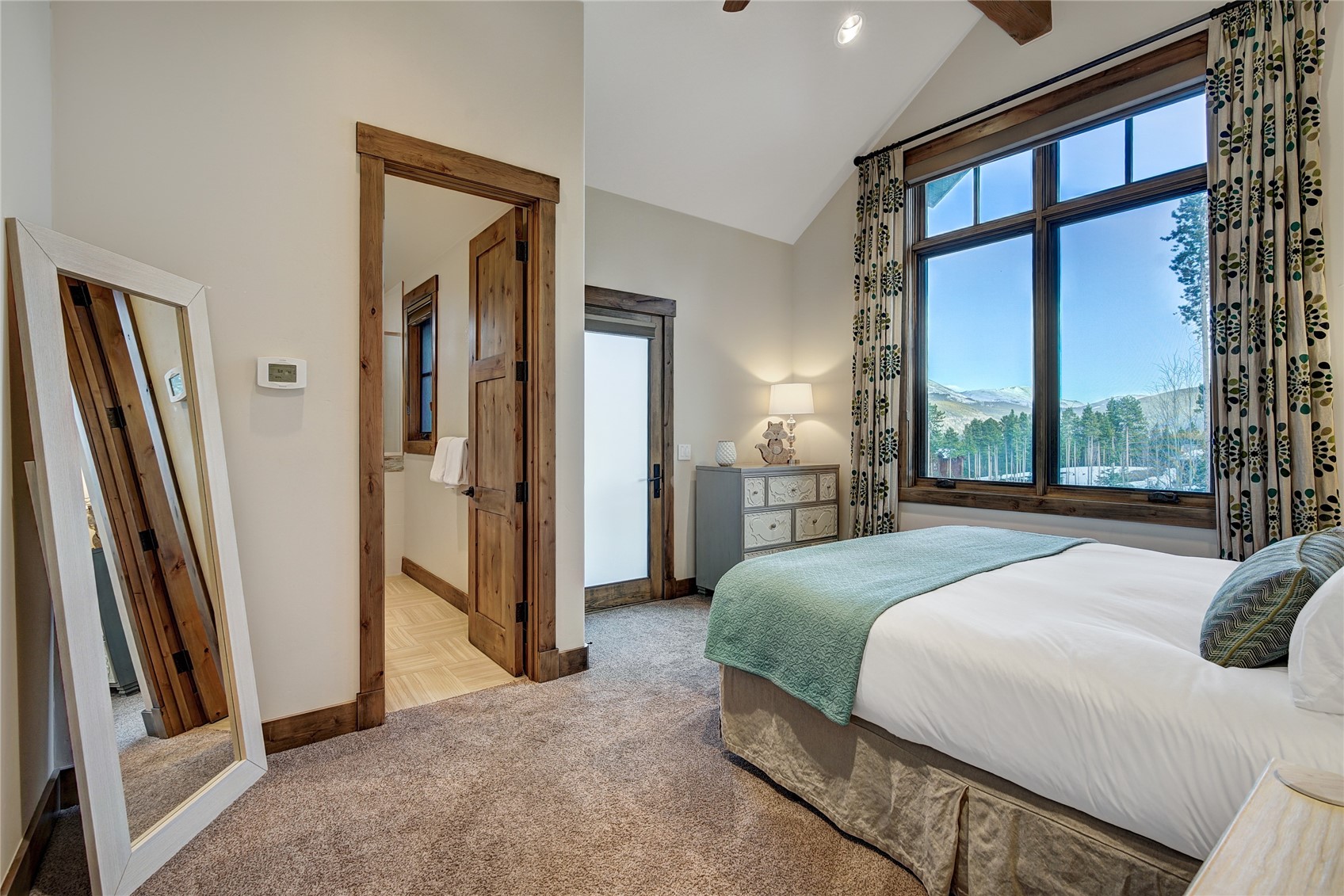 422 Timbertrail Road Breckenridge, CO 80424 - Photo 33 of 50 a bedroom with a bed and a large mirror next to a window