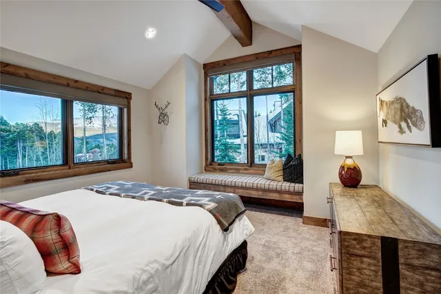 a bed room with a bed and a chair