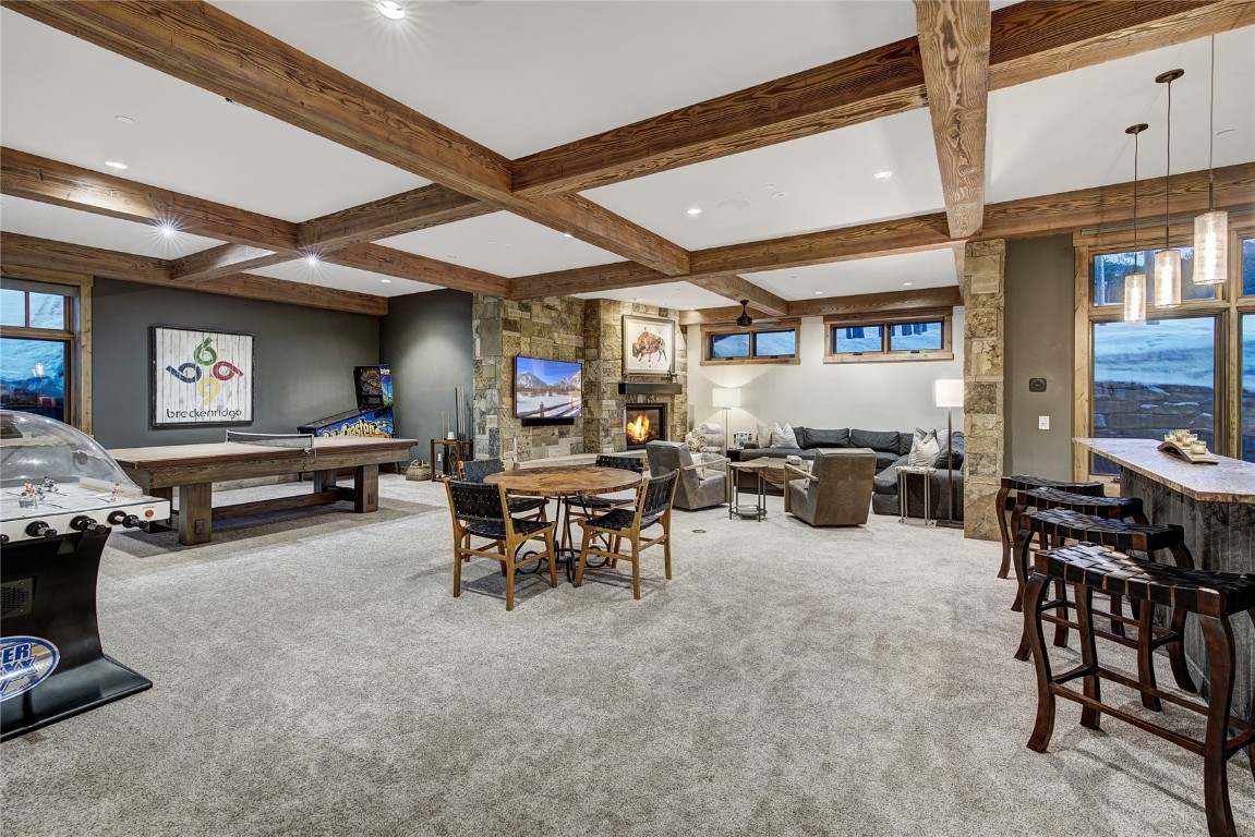 422 Timbertrail Road Breckenridge, CO 80424 - Photo 38 of 50 a living room with furniture a fireplace and a large window