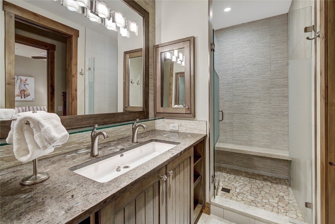 422 Timbertrail Road Breckenridge, CO 80424 - Photo 47 of 50 a bathroom with a granite countertop sink and a mirror