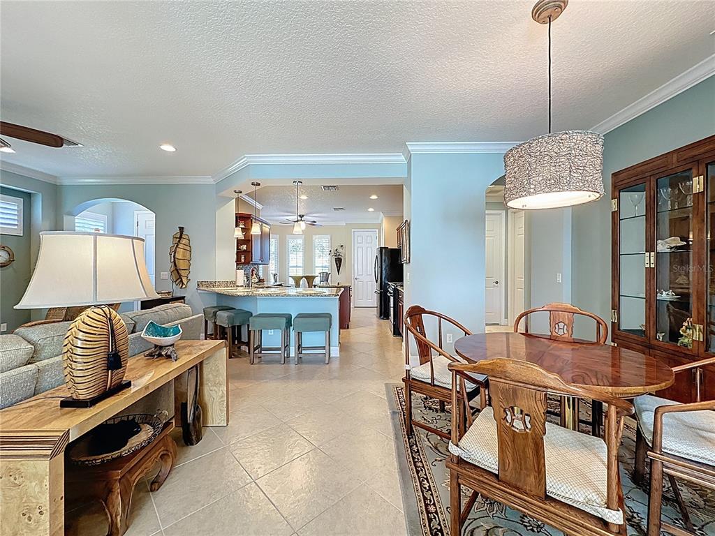 404 Silver Maple Road Groveland, FL 34736 - Photo 11 of 40 a dining room with furniture and window