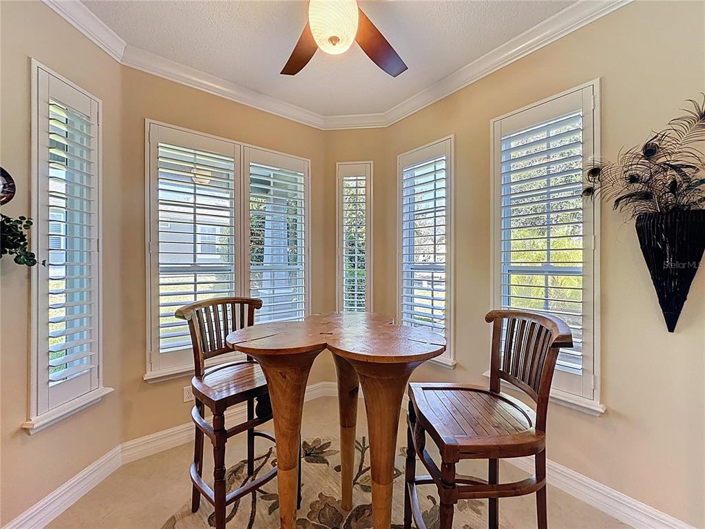 404 Silver Maple Road Groveland, FL 34736 - Photo 19 of 40 a view of a dining room with furniture and windows