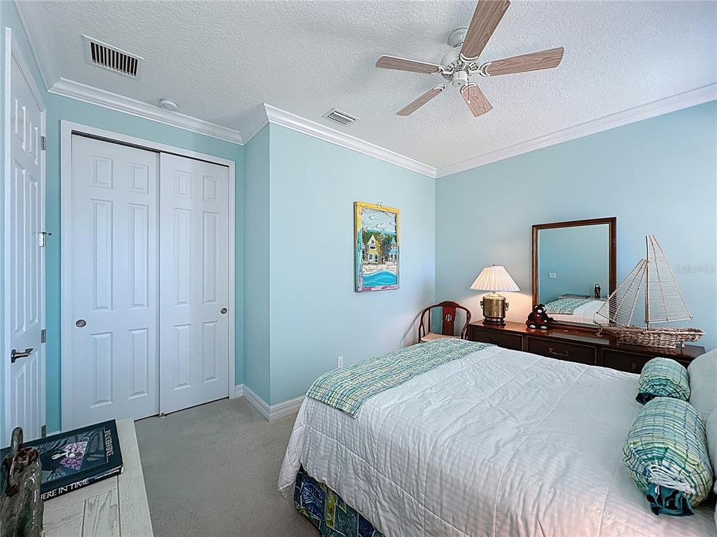 404 Silver Maple Road Groveland, FL 34736 - Photo 24 of 40 a bedroom with a bed and a chandelier