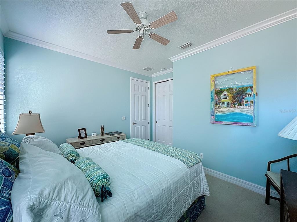 404 Silver Maple Road Groveland, FL 34736 - Photo 25 of 40 a bedroom with a bed and a painting on the wall