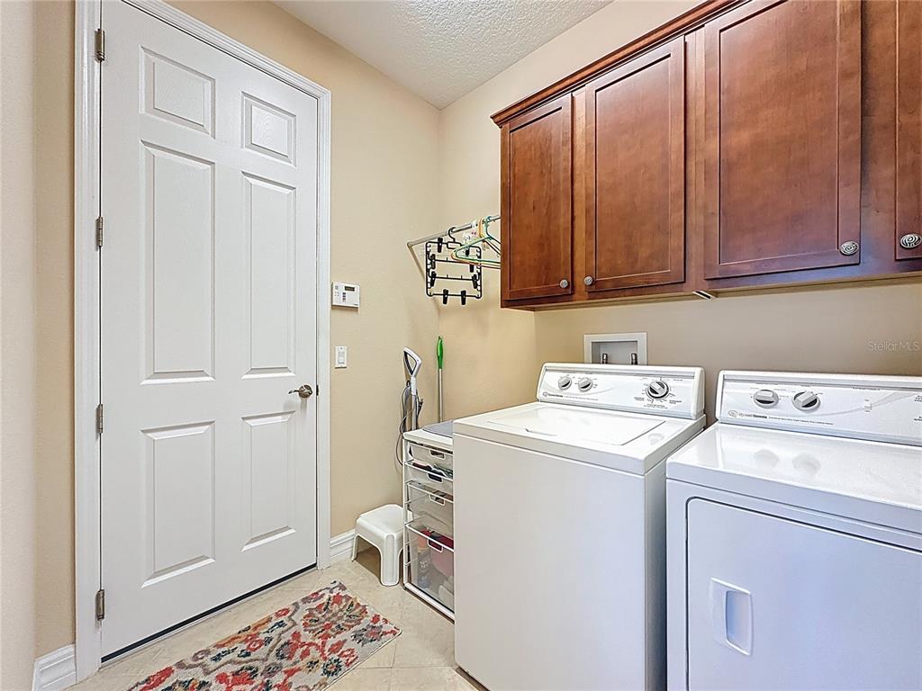 404 Silver Maple Road Groveland, FL 34736 - Photo 27 of 40 a utility room with dryer and washer