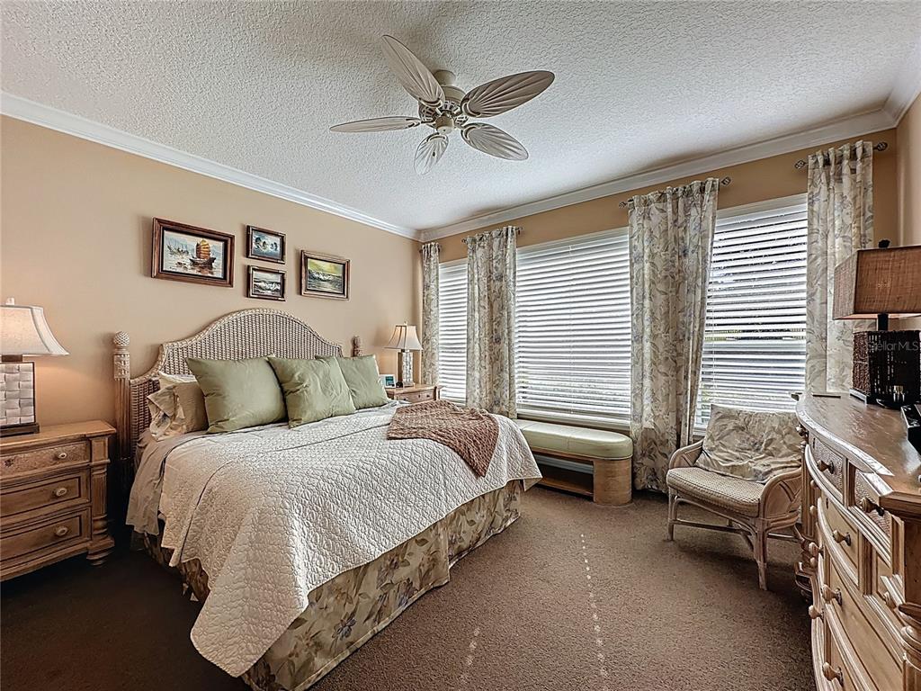 404 Silver Maple Road Groveland, FL 34736 - Photo 28 of 40 a bedroom with a bed and a window