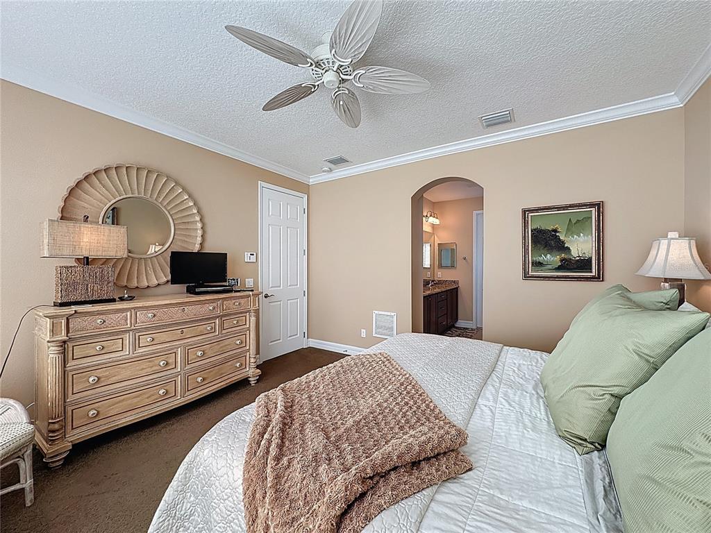 404 Silver Maple Road Groveland, FL 34736 - Photo 30 of 40 a bedroom with a bed and a dresser
