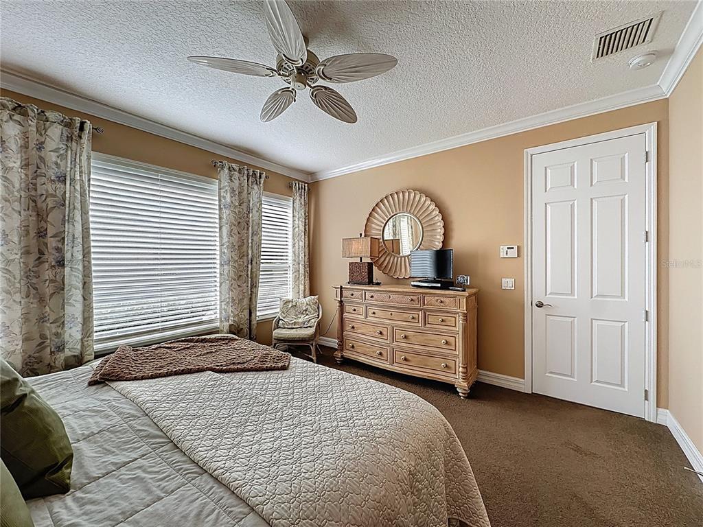 404 Silver Maple Road Groveland, FL 34736 - Photo 31 of 40 a bedroom with a bed dresser and a window