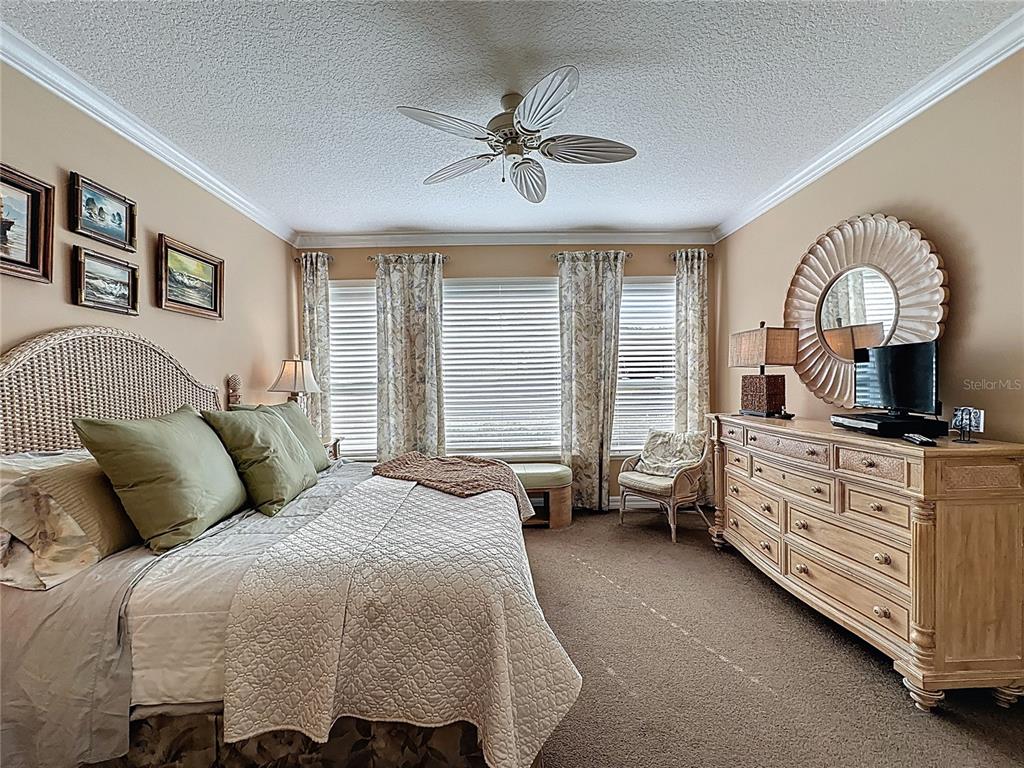 404 Silver Maple Road Groveland, FL 34736 - Photo 32 of 40 a bedroom with a bed a couch and dresser