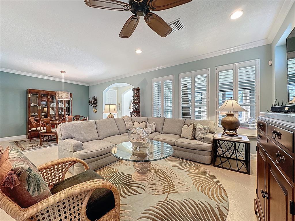 404 Silver Maple Road Groveland, FL 34736 - Photo 6 of 40 a living room with furniture or couch and a large window