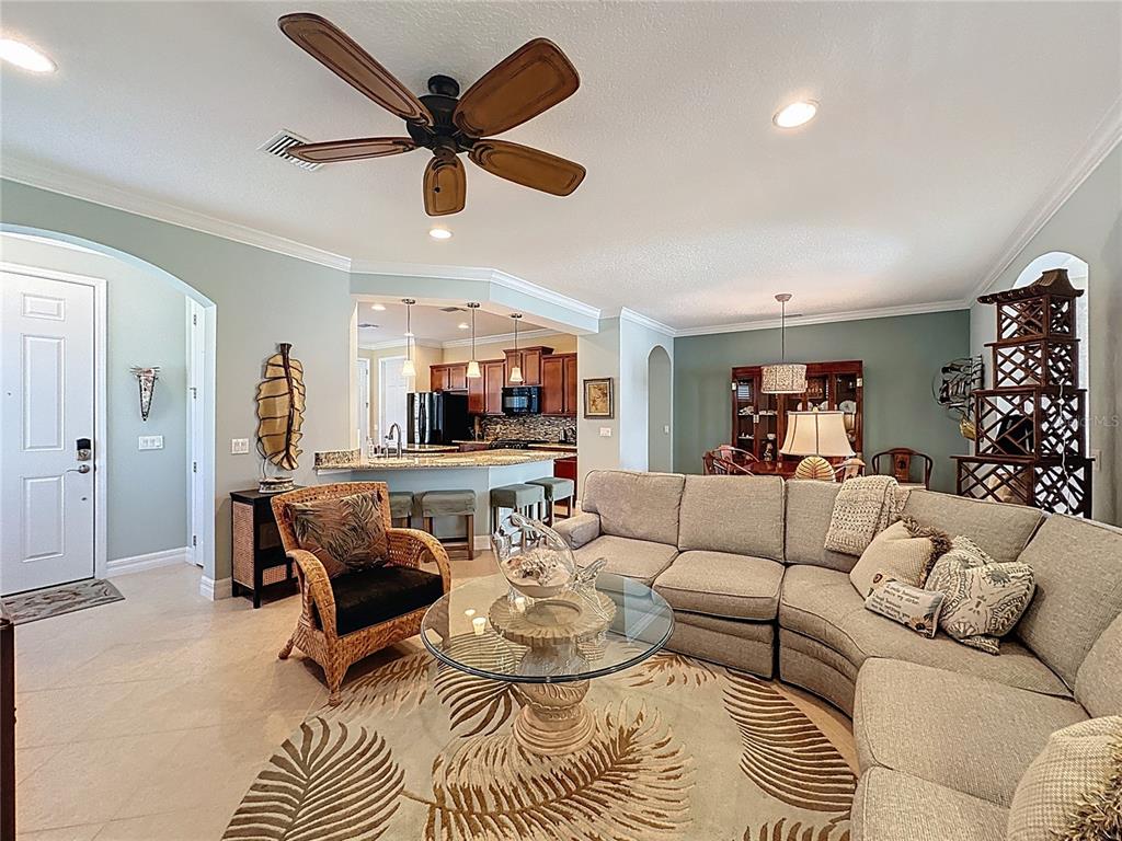 404 Silver Maple Road Groveland, FL 34736 - Photo 9 of 40 a living room with furniture a ceiling fan and a window