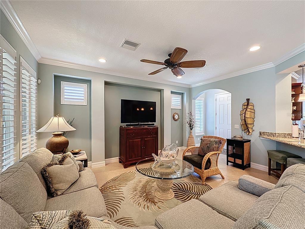404 Silver Maple Road Groveland, FL 34736 - Photo 10 of 40 a living room with furniture a window and a flat screen tv