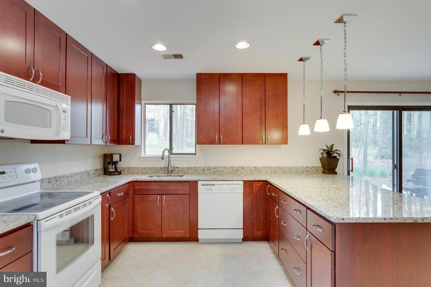 12348 Lima Lane Reston, VA 20191 - Photo 12 of 26 a kitchen with stainless steel appliances granite countertop wooden cabinets a sink and dishwasher