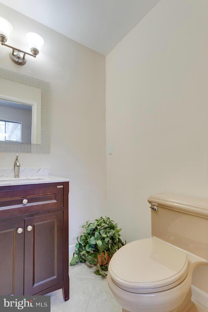 12348 Lima Lane Reston, VA 20191 - Photo 16 of 26 a bathroom with a toilet a sink and mirror
