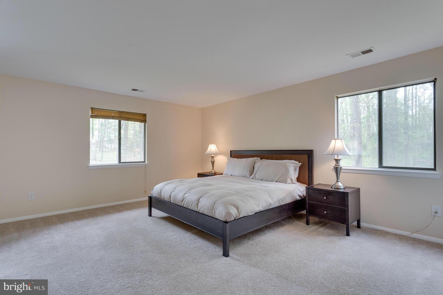 12348 Lima Lane Reston, VA 20191 - Photo 17 of 26 a bedroom with a bed lamp and window