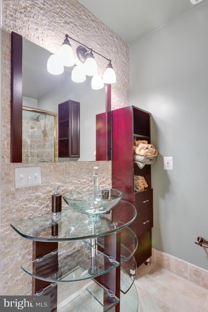 12348 Lima Lane Reston, VA 20191 - Photo 20 of 26 a kitchen with stainless steel appliances kitchen island granite countertop a table chairs in it and wooden floors
