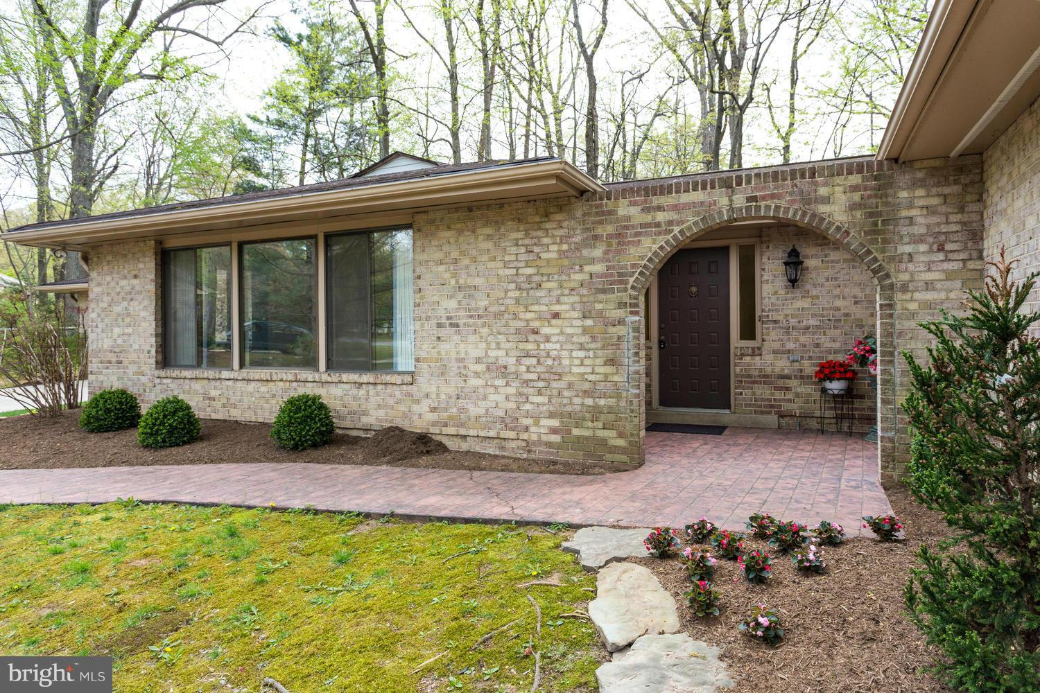 12348 Lima Lane Reston, VA 20191 - Photo 3 of 26 a front view of a house with garden