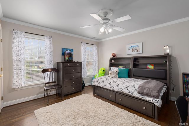 a bedroom with a bed and a dresser in it