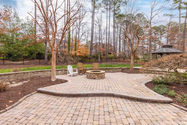 a view of a yard with plants and trees